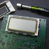 Install the LCD and its elastomeric connector. Carefully clip the bezel back on to hold it in place.