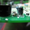 Piezo buzzer, trim pot, and swelled capacitor. There appears to be an alien creature crawling out of the pot.