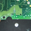 Various parts of the circuit board are covered in patches of white powdery residue.