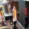 The Nixie tubes and neon lamps are driven with half-wave rectified AC from a high-voltage winding on the power transformer. Bulbs are twisted so that the lighted electrode faces front.